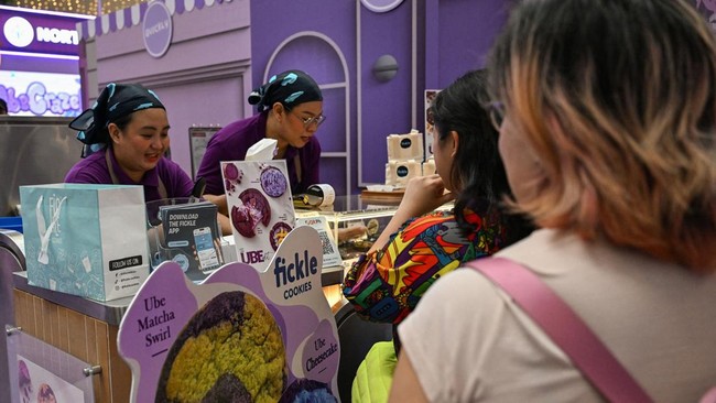 This photo taken on September 23, 2026 shows customers buying ube cookies during a purple yam promotional event at a mall in Quezon City, Metro Manila. The Philippine ube has become a trend-setting sensation from Los Angeles to London to Seoul, with