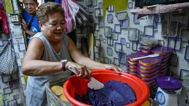 This photo taken on October 1, 2026 shows a worker preparing purple yam jam (ube halaya) at a shop in Manila. The Philippine ube has become a trend-setting sensation from Los Angeles to London to Seoul, with the humble yam's bright purple hue drawing