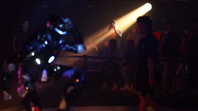 A man films an EngineAI T800 robot during ARC League's humanoid combat competition in Singapore October 7, 2026. REUTERS/Edgar Su
