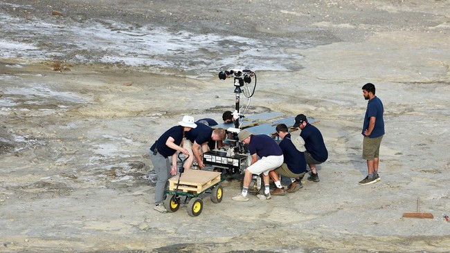 Members of the testing team place on the floor a six-wheeled Mars rover prototype known as Charlie during a test by the European Space Agency (ESA), Airbus and other European partners, testing technologies and operational procedures for ESA's ExoMars
