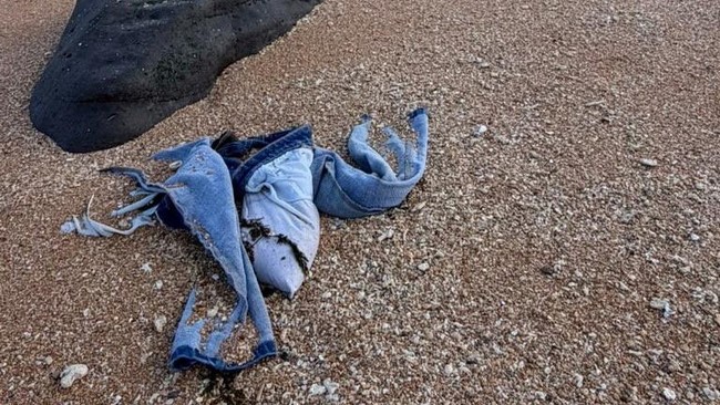 A pair of trousers believed to belong to a migrant lies on the shore after a boat carrying about 305 people capsized while sailing from Djibouti to Yemen, leaving at least 109 migrants, including 15 children, dead and more than 116 missing, according