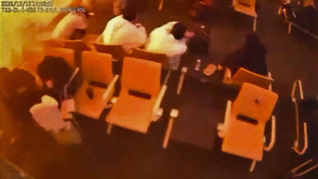 Surveillance footage shows people sitting in a waiting area reacting at the moment of an attack, in a location given as King Khalid International Airport in Riyadh, Saudi Arabia, October 10, 2026, in this frame from a handout video. Saudi Ministry of