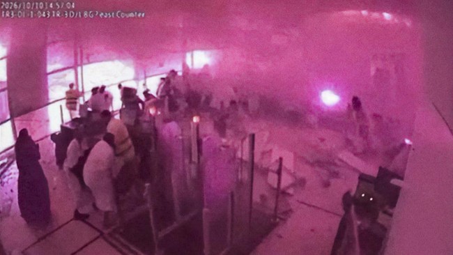 Surveillance footage shows smoke and fire as people react at the moment of an attack at King Khalid International Airport in Riyadh, Saudi Arabia, October 10, 2026, in this frame from a handout video. Saudi Ministry of Media/Handout via REUTERS    TH