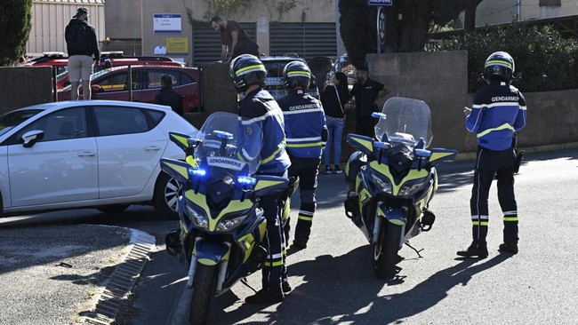 French gendarmes stand in front of Joseph-Lakanal middle school after a headmaster was injured by a hunting rifle shot and a teenager was arrested in Aubagne, southern France, on October 12, 2026. The school head was hit by a 12-gauge hunting rifle s