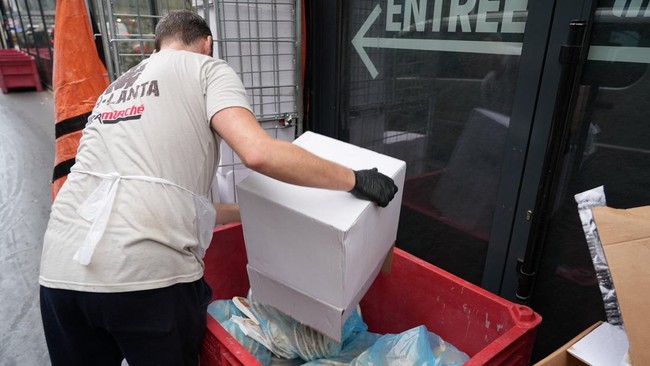 An employee fills boxes of perished goods outside an Intermarche supermarket in Paris the day after a cyberattack targeted refrigeration systems at French supermarket chains, causing food losses and fires at several stores, France, October 13, 2026.