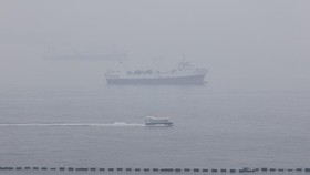 Haze shrouds ships anchored off the southern coast of Singapore as smoke from regional forest fires reduces visibility across the island city-state, October 14, 2026. REUTERS/Suhaimi Abdullah