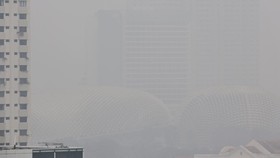 This picture provided by The Straits Times taken and received on October 14, 2026 shows buildings shrouded with haze in Singapore. Air pollution in western Singapore hit the country's "very high" band on October 14, the environment agency said, as ha