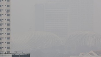 This picture provided by The Straits Times taken and received on October 14, 2026 shows buildings shrouded with haze in Singapore. Air pollution in western Singapore hit the country's "very high" band on October 14, the environment agency said, as ha
