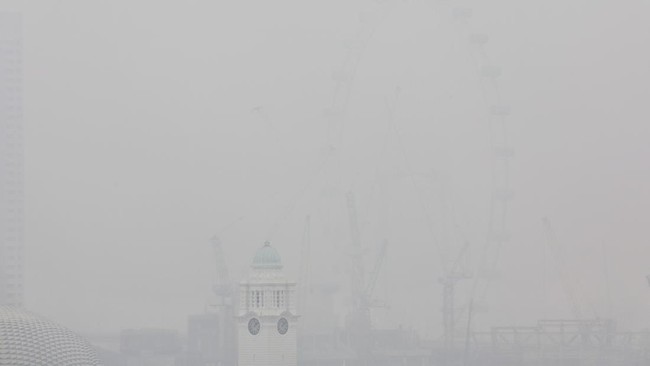 This picture provided by The Straits Times taken and received on October 14, 2026 shows the city shrouded with haze in Singapore. Air pollution in western Singapore hit the country's