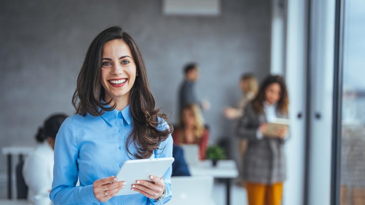 Urban happy business woman using tablet computer and working&period; Happy businesswoman using a digital tablet&period; Young leading businesswoman using a wireless tablet&period; Designer standing in her office using an online app