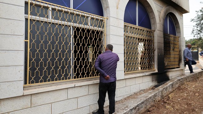 Palestinians inspect a mosque, which Palestinians say was burned by Israeli settlers, in Mukhmas, near Ramallah in the Israeli-occupied West Bank, October 14, 2026. REUTERS/Ammar Awad