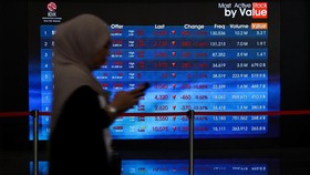 A worker walks past an electronic board displaying stock movement at the Indonesia Stock Exchange (IDX) in Jakarta, Indonesia, October 16, 2026. REUTERS/Ajeng Dinar Ulfiana