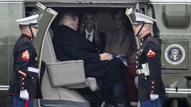 US President Donald Trump speaks with White House Press Secretary Katie Zacharia and aide Natalie Harp after boarding Marine One at Elmendorf Air Force Base in Anchorage, Alaska, on October 13, 2026. President Trump is traveling to Wasilla, Alaska to