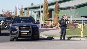 An emergency worker holds up police tape at the scene of a shooting at Silver Rail Elementary School in Bend, Oregon, US, October 15, 2026.    REUTERS/Rob Kerr