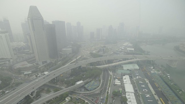 The skyline and Formula One pit building is seen in Singapore on October 15, 2026, as the country continues to be shrouded in haze caused by fires in Indonesia. Toxic haze has covered parts of Indonesia, Malaysia and Singapore for weeks as Jakarta st