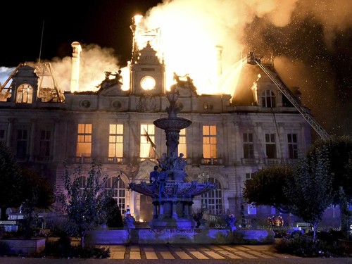 This photograph shows a fire burning and destroying the city hall after a group of individuals forced entry into the building during ongoing protest action against the "high cost of living", in Limoges, central France on October 17, 2026 as part of a