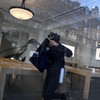 A protester steals an Apple screen at the Apple Store which has been ransacked during ongoing protest action against the "high cost of living", in Lille, northern France, on October 17, 2026 as part of a nationwide call for mobilisation bringing toge