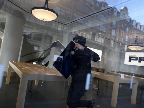 A protester steals an Apple screen at the Apple Store which has been ransacked during ongoing protest action against the "high cost of living", in Lille, northern France, on October 17, 2026 as part of a nationwide call for mobilisation bringing toge