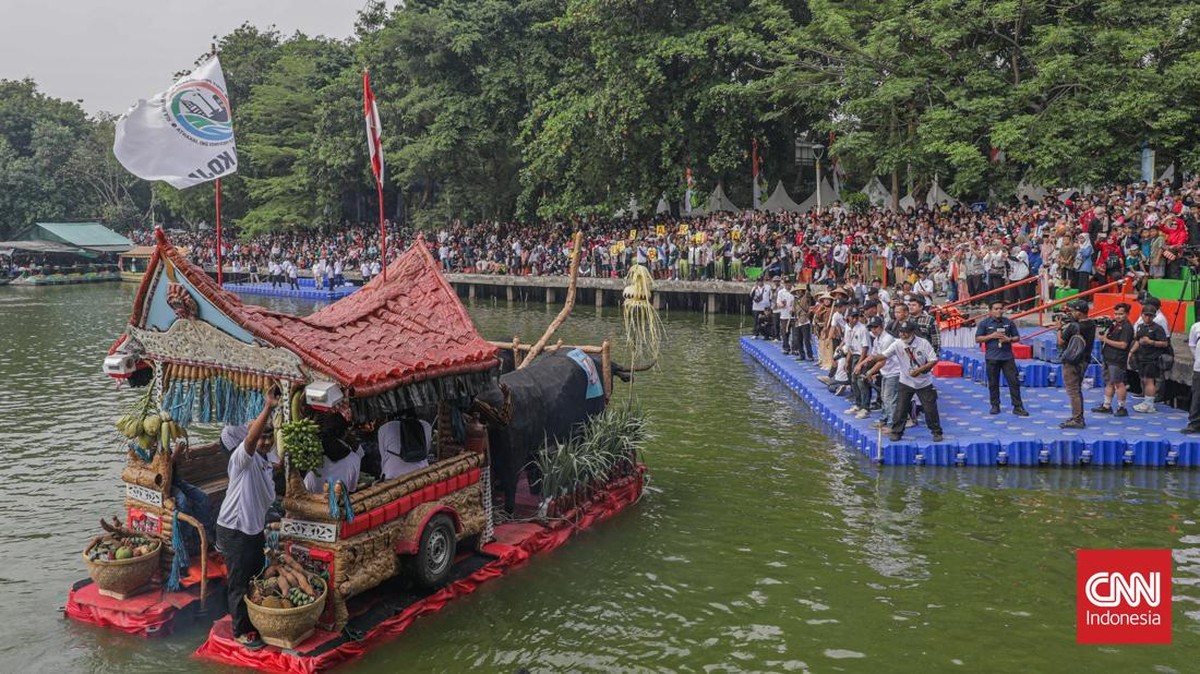 Warga menyaksikan parade perahu berbahan limbah botol plastik dan galon dalam Festival Cinta Lingkungan (Cilung) di Danau Sunter, Jakarta, Minggu (18/10). (CNN Indonesia/Febria Adha L)