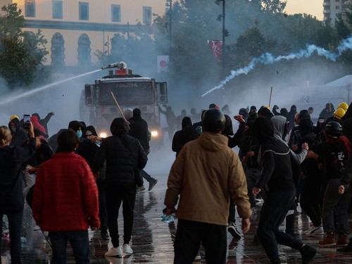Protesters rush toward water cannons during an anti-government protest by students in Tirana, Albania, October 18, 2026. REUTERS/Louisa Gouliamaki