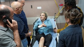 Heidi Levine, a photojournalist with the Washington Post, speaks to journalists at the hospital after sustaining multiple injuries during an attack by Israeli militant settlers on Palestinians harvesting olives, in Ramallah in the Israeli-occupied We