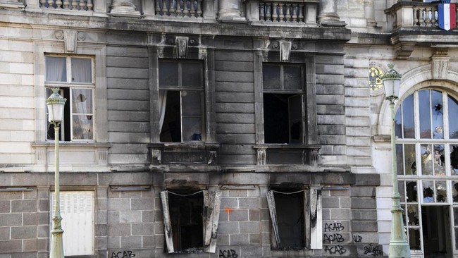 This photograph shows a portion of the partially burnt facade of the Limoges city hall a day after riot and looting following nationwide protests against the
