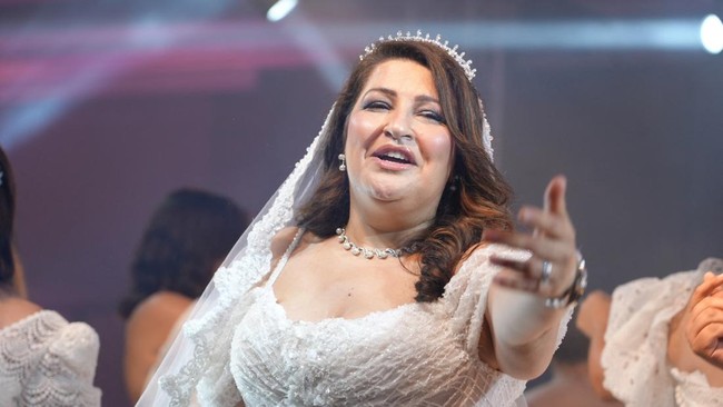 A woman reacts as twenty-two breast cancer patients and survivors take part in the fifth edition of the Warrior Fashion Show, organized by Femmes Maghrebines magazine during its annual Pink October awareness campaign to promote early detection and ch