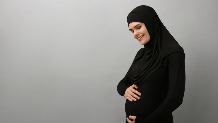Portrait of pregnant Muslim woman in hijab on light gray background&comma; space for text