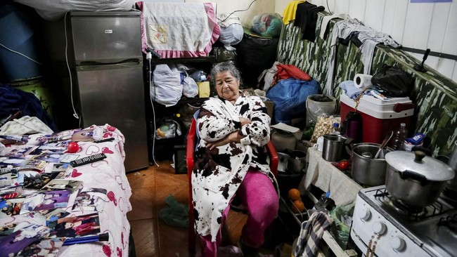 A woman sits in a shelter after being displaced from her home due to flooding, in Ciudad del Este, Paraguay, October 22, 2026. REUTERS/Cesar Olmedo