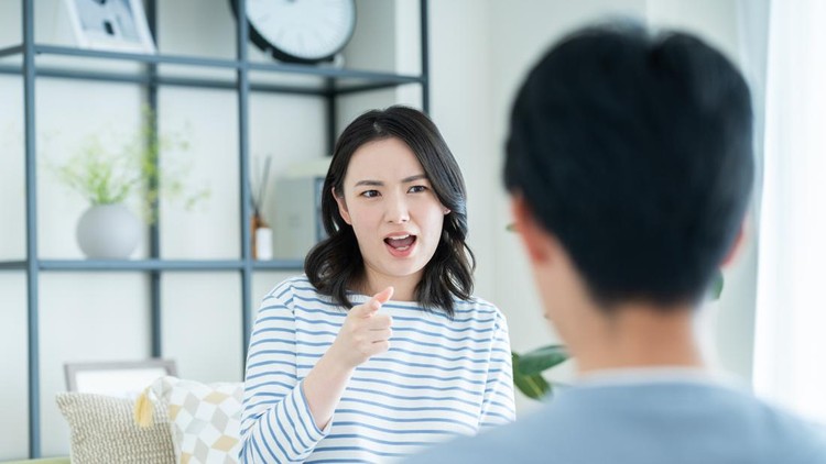 A young couple arguing in the living room