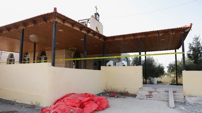 The grounds of Saint Georges Greek Orthodox Church, where gunmen opened fire during a funeral the previous day, is cordoned-off, in the village of Hamoud, Karak, Jordan, October 24, 2026. REUTERS/Alaa Al Sukhni