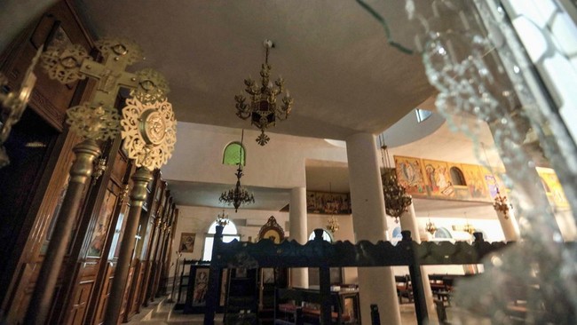 This photo shows a general view of the damage inside the Greek Orthodox Church in the village of Hammoud in Karak governorate on October 23, 2026 in the aftermath of a shooting attack. Gunmen killed at least seven people and wounded dozens at a churc