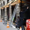 Workers install panels to protect the storefront windows of a Louis Vuitton store in Lyon, ahead of nationwide protests against the cost of living and rising fuel prices in France, October 23, 2026. REUTERS/Lisi Niesner