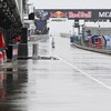 A person stands on a deserted pit lane as rain falls while officials wait for Race Control on a decision on the running of the Australian MotoGP Grand Prix on Phillip Island October 25, 2026. (Photo by Paul Crock / AFP) / --IMAGE RESTRICTED TO EDITOR