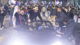 Supporters of the Students List gather at the National assembly building as they celebrate their victory in the Serbian parliamentary elections, in Belgrade in the early hours of October 26, 2026. Voters cast ballots in record numbers on October 25,