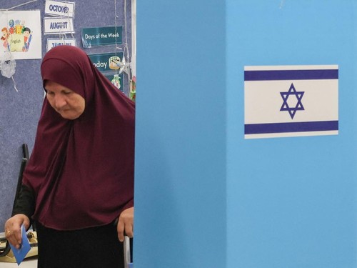 A woman prepares to cast her ballot to vote at a polling station in the Arab-Israeli town of Umm al-Fahm on October 27, 2026, on the day of Israel's legislative election. Israelis began voting on October 27 in the first general election since Hamas's