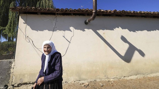 The 117-year-old Qamile Marra poses during an interview with AFP in the garden of her home in the village of Ferras, near Kucove, some 80 kilometres from the Albanian capital Tirana on October 3, 2026. At 117, Qamile Marra's priority isn't proving sh
