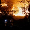 Firefighters walk in front of the scene of the fire as a fire broke out in Guryong village in Seoul, South Korea, October 27, 2026. REUTERS/Kim Soo-hyeon
