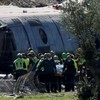 Rescue teams work at the site following the collision of two high-speed trains between the towns of Mora and Orgaz, near Toledo, Spain, October 28, 2026. REUTERS/Violeta Santos Moura