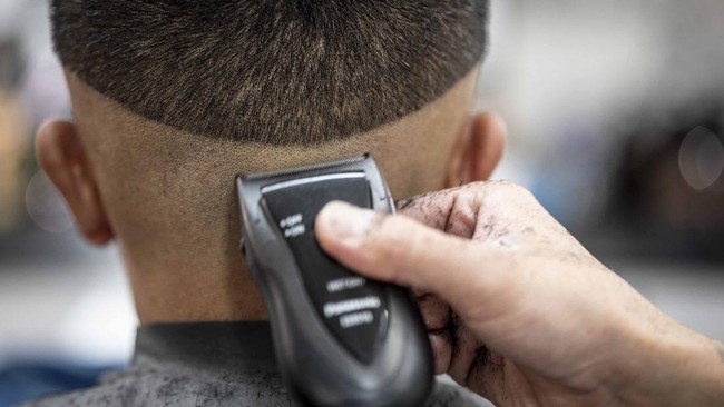 This photo taken on August 27, 2026 shows Tekisasu, an active yakuza gangster allied to a major clan, having his hair cut at a barbershop in Tokyo. Japan's yakuza operate an organised crime empire worth billions of dollars and have long dominated the