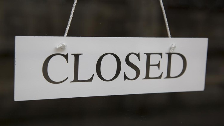 White Closed Sign on Shop Door